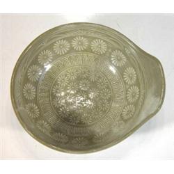 Small slate coloured oriental shallow lipped bowl with incised flowerheads, 13cm in diameter…