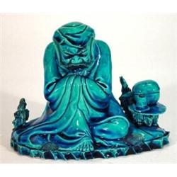 Chinese blue glazed ceramic figure of a bearded gentleman in robe seated beside a table, 12cm hig…