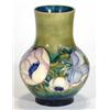 Image 1 : Moorcroft vase hand painted with an anemone pattern onto a green and blue ground, incised signatu…