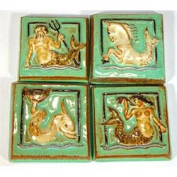 Four green and brown glazed square Studio Pottery tiles moulded with mythical sea creatures and G…