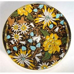 Boch Freres twin handled shallow bowl enamelled with blue and yellow flowers onto a black ground,…