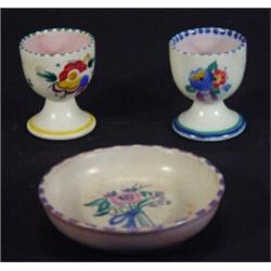 Poole Carter Stabler Adams floral dish and two Poole pottery eggcups with hand painted floral des…