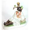 Image 1 : Hand painted Continental porcelain figure of a seated boy playing a flute, 23cm in length…