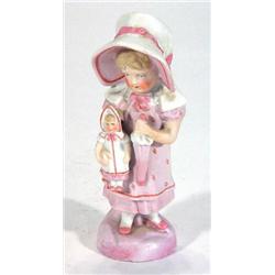 Victorian bisque figurine of a girl in a pink dress and bonnet clutching a doll and umbrella, 15c…