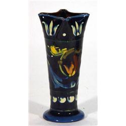 Torquay ware vase, decorated with stylised flowers onto a blue ground, 12cm high…