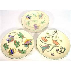 Two hand painted Honiton pottery plates, created with stylised flowers, marks to back, 23cm diame…