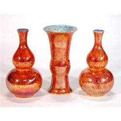 Pair of orange lustre glazed Wilton ware double gourd vases and matching flared vase, marks to ba…