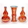 Pair of orange lustre glazed Wilton ware double gourd vases and matching flared vase, marks to ba…
