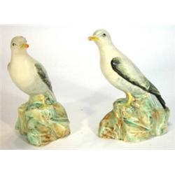 Two hand painted Radford style seated pottery seagulls on rocky bases, 22cm high…