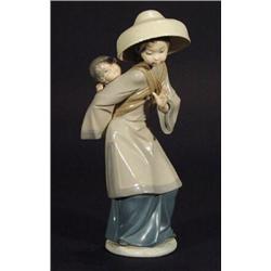 Hand painted Lladro oriental figurine with child on back and straw hat, impressed and printed mar…