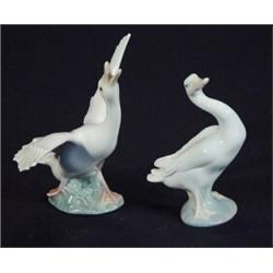 Lladro goose with raised wings and a seated Lladro goose, printed marks to base, largest 14cm hig…