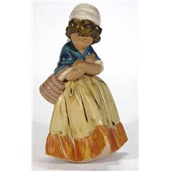 Lladro figurine of girl clutching a basket with crossed arms, glazed in blues, oranges and browns…