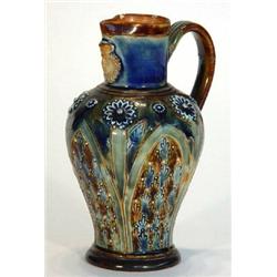 Doulton Lambeth stoneware jug with applied masks and incised floral decoration, impressed marks t…