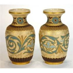 Pair of Doulton Lambeth stoneware vases decorated with blue incised swags onto a gilded and cream…