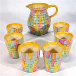 Hampton ivory ware jug and six matching ribbed beakers, hand painted in pink, green, yellow and b…