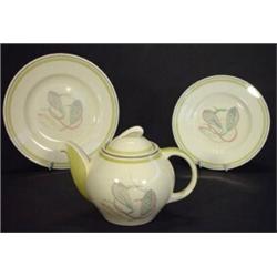 Susie Cooper kestrel shaped teapot and two plates, decorated with stylised leaves, marks to base…