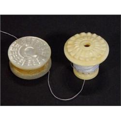 Carved mother-of-pearl cotton waxer and a carved ivory cotton reel…