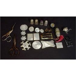 Selection of sewing items including floral chased thimbles, mother-of-pearl cotton winders, silve…