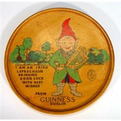 Circular wooden Guinness advertising plaque, hand painted with an Irish leprechaun, 32cm diameter…