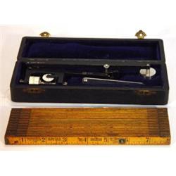 Cased Amsler planimeter and a wooden expanding master rule…