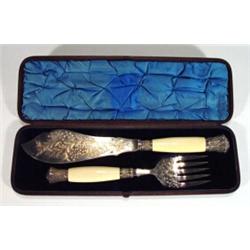 Cased ivorine handled silver plated serving knife and fork engraved with sprigs of leaves and flo…