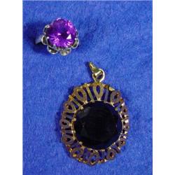 Silver and purple stone dress ring and a smoky coloured stone gold pendant…