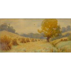 Gilt framed watercolour of corn stacks in a field beside tree and cattle, L H harris, 15x32cms…