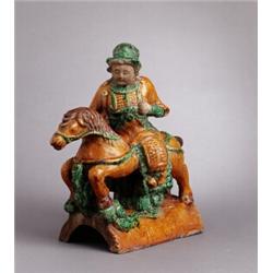 A LATE MING HORSE AND RIDER, green- and, A LATE MING HORSE AND RIDER, green- and brownglazed ea...