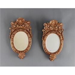 A pair of baroque cut giltwood GIRANDOLES, in the, A pair of baroque cut giltwood GIRANDOLES, i...