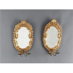 A set of two rococo giltwood two-light, A set of two rococo giltwood two-light GIRANDOLES, 49 x...