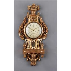 A Swedish late 18th century giltwood CARTEL, A Swedish late 18th century giltwood CARTEL CLOCK,...