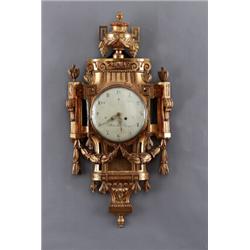 A Swedish late 18th century giltwood CARTEL, A Swedish late 18th century giltwood CARTEL CLOCK,...