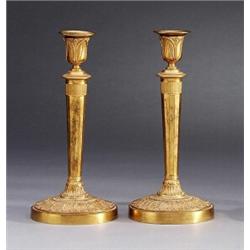 A pair of empire partly gilt bronze CANDLESTICKS,, A pair of empire partly gilt bronze CANDLEST...