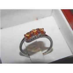RING - FANCY ORANGE SAPPHIRE & DIAMOND RING - 1.25 CTW OVAL SAPPHIRES IN AN OFFSET DESIGN - VS QUALI