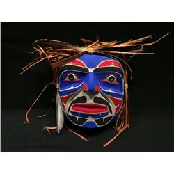 EMIL THIBERT, ''MOON MASK', HAND CARVED CEDAR WITH CEDAR STRIPS AND FEATHERS , SOULTEAUX NATION