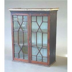 A George III display cabinet, enclosed by a pair of astragal glazed fruitwood doors, 2ft.10ins....