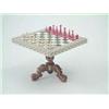 Image 1 : A mid 19th century Indian ivory miniature chess set and table, the small turned pieces in red sta...