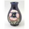 Image 1 : A small Moorcroft Pansy vase, baluster shape painted against a dark blue ground, facsimile signat...