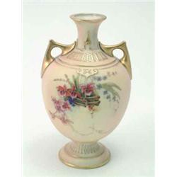 A late Victorian Royal Worcester vase, two-handled and painted with a basket of flowers against a...
