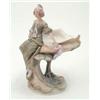 Image 1 : A Royal Dux centrepiece, modelled as a young woman in long green dress, seated beside leaf-encrus...