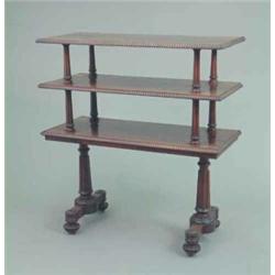 A Regency rosewood three tier buffet, with rectangular ovolo moulded shelves on fluted tapered co...