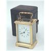 Image 1 : A brass carriage timepiece, with enamelled dial and French movement, in obis case, in leather tra...