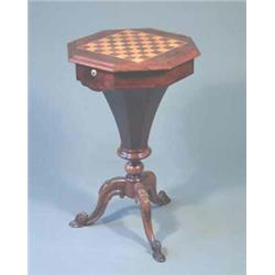 A Victorian rosewood octagonal trumpet work table with chessboard top on floral carved tripod, 1f...