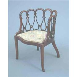 An Edwardian mahogany tub chair with ornate openwork back and tapestry seat on square tapered leg...