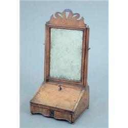 A Victorian Queen Anne design walnut toilet mirror, with bevelled plate over a bureau style base,...