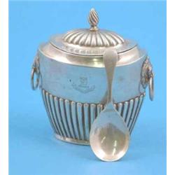 A late Victorian silver tea caddy of demi fluted oval form, together with a later caddy spoon....