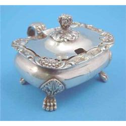 A George III silver mustard of rounded rectangular form with acanthus knop and handle, on lions p...