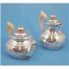 Image 1 : A George V silver teapot and matching hot water pot of compressed circular form with cut card dec...