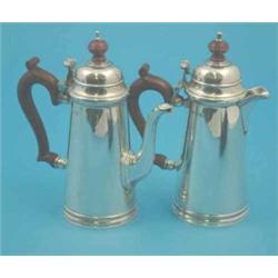 A pair of George V silver cafe au lait pots with scroll handles, Birmingham 1935, Gross 21.5 oz....
