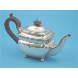 A George III silver teapot of plain rectangular form with ebonised handle and ball feet, Makers P...